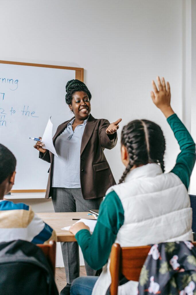 Teaching at the front of a classroom of children